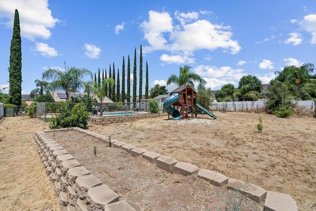 view of jungle gym featuring a fenced in pool