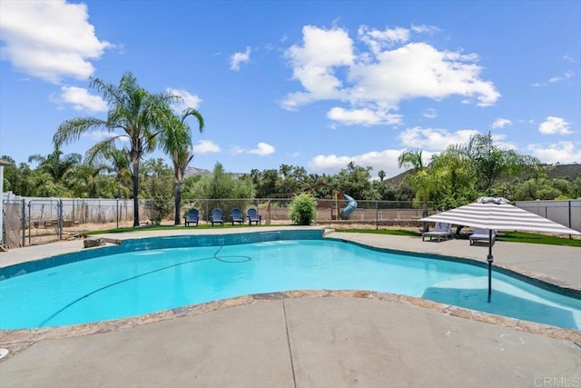 view of pool with a patio area, a fenced in pool, and fence