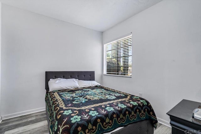 bedroom with wood-type flooring