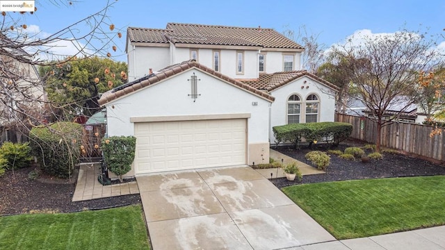 mediterranean / spanish-style house featuring a garage and a front lawn