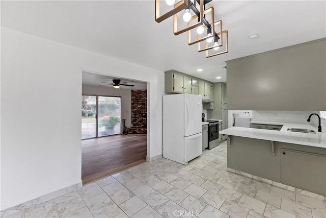 kitchen featuring sink, green cabinets, stainless steel range with electric stovetop, white refrigerator, and kitchen peninsula