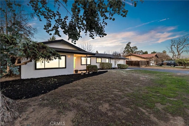 ranch-style home with a lawn