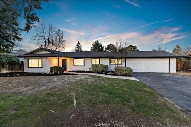 single story home featuring a yard and a garage