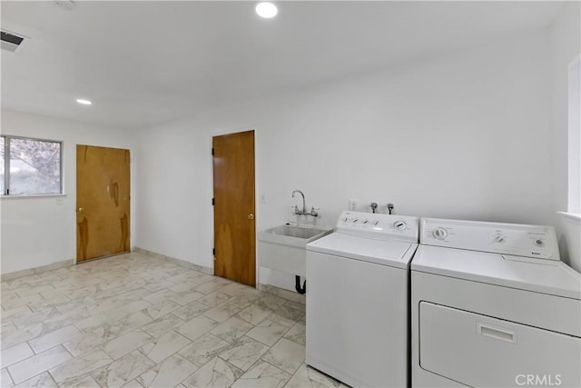 laundry room with washing machine and dryer and sink