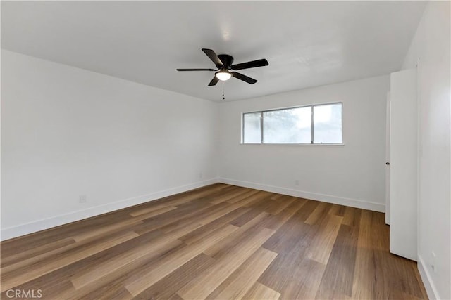 unfurnished room with ceiling fan and hardwood / wood-style floors