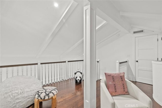 living area featuring lofted ceiling with beams and dark wood-type flooring