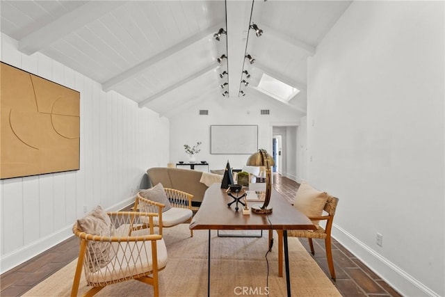 sitting room featuring vaulted ceiling with skylight