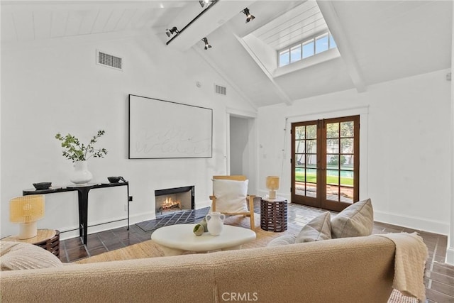 living room featuring high vaulted ceiling, track lighting, beam ceiling, and french doors