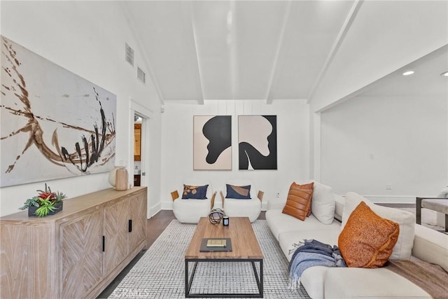 living room with wood-type flooring and vaulted ceiling with beams