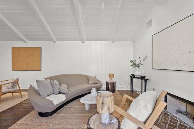 living room with vaulted ceiling with beams and dark wood-type flooring