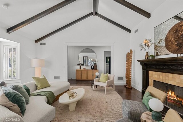 living room featuring beamed ceiling, a fireplace, dark hardwood / wood-style flooring, and high vaulted ceiling