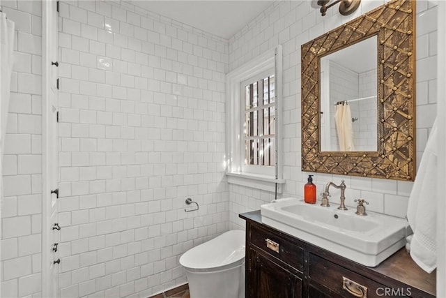 bathroom with tile walls, vanity, toilet, and walk in shower