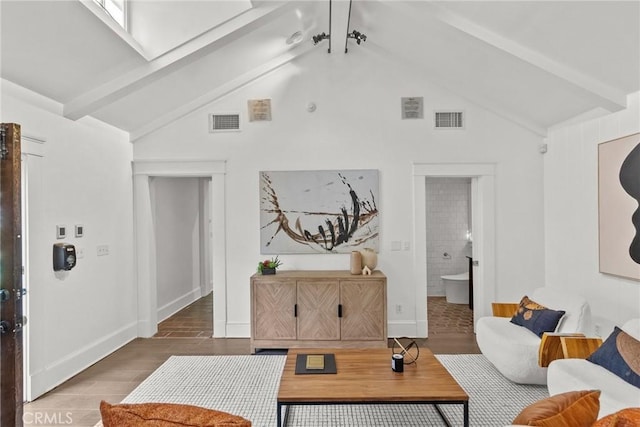 living room featuring lofted ceiling with beams and dark hardwood / wood-style flooring