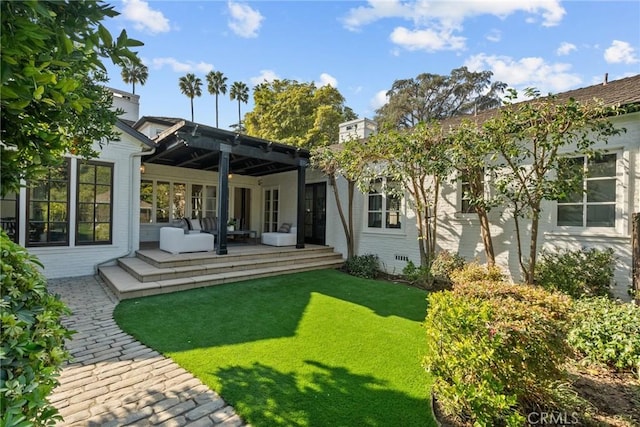 rear view of house with a yard, an outdoor hangout area, and a patio