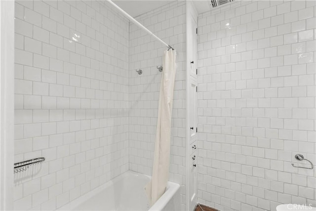 bathroom with toilet and shower / bathtub combination with curtain