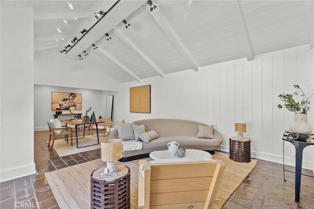 living room featuring vaulted ceiling with beams