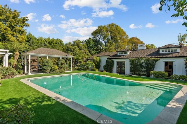 view of pool featuring an outbuilding and a yard