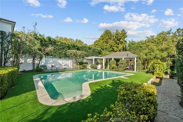 view of swimming pool featuring an outbuilding and a lawn