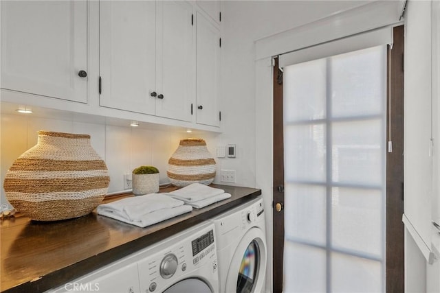 washroom with cabinets and separate washer and dryer