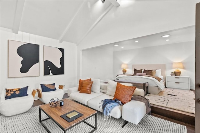 bedroom with hardwood / wood-style flooring, beam ceiling, and high vaulted ceiling