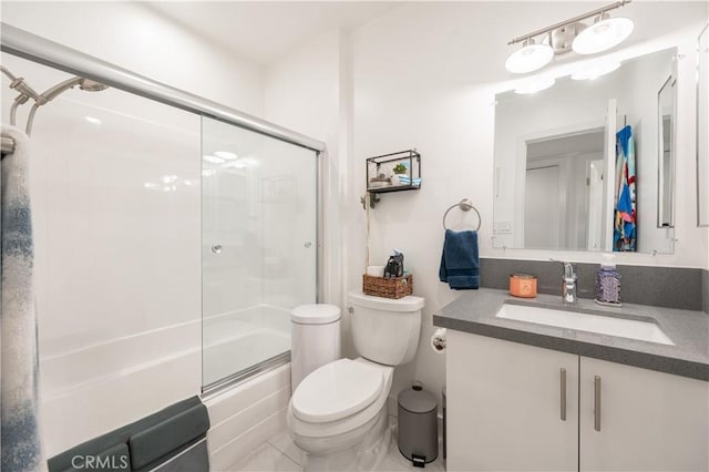 full bathroom featuring vanity, shower / bath combination with glass door, and toilet