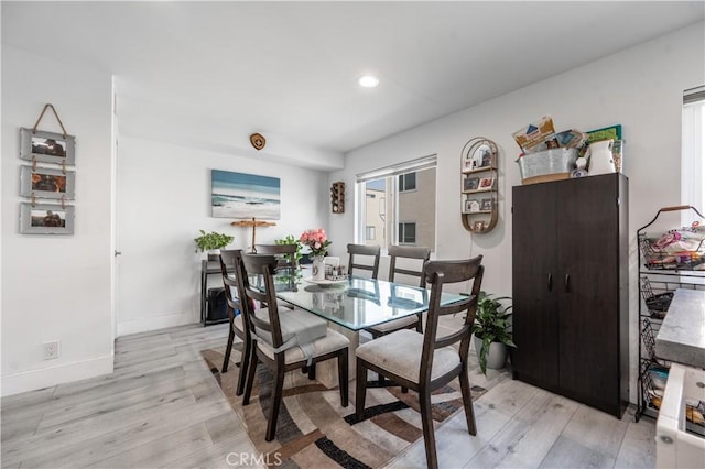 dining space with light wood-type flooring