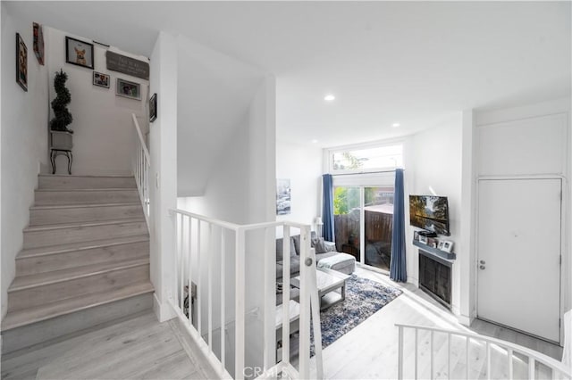 stairway featuring wood-type flooring