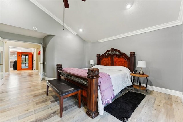 bedroom with lofted ceiling, ceiling fan, wood finished floors, baseboards, and crown molding