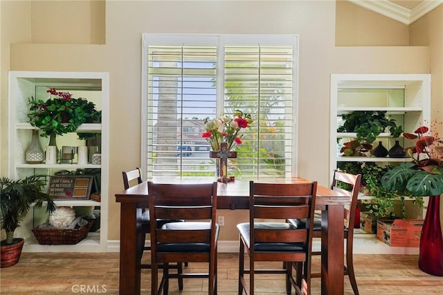 dining room featuring ornamental molding and wood finished floors