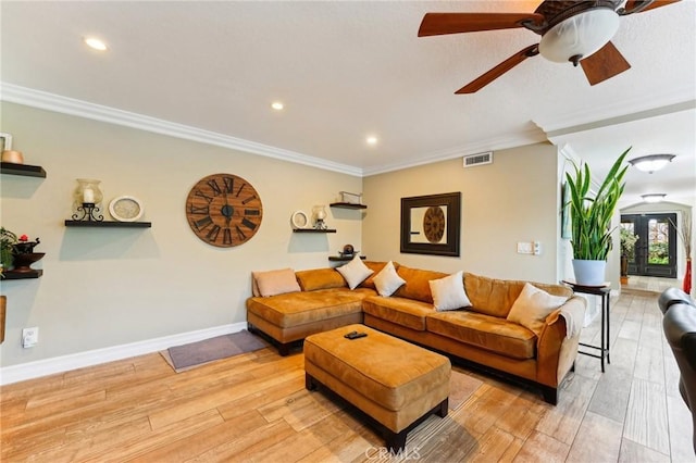 living room featuring crown molding, ceiling fan, and light hardwood / wood-style flooring