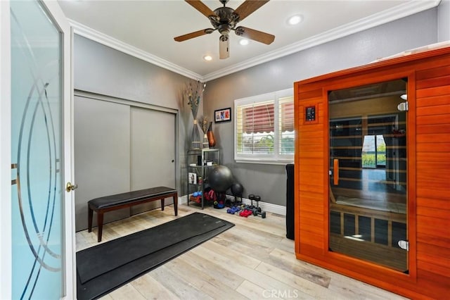 workout room with recessed lighting, wood finished floors, baseboards, a sauna, and crown molding