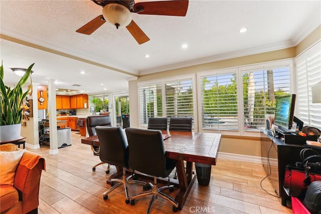 interior space with light wood-style flooring, a textured ceiling, baseboards, and crown molding