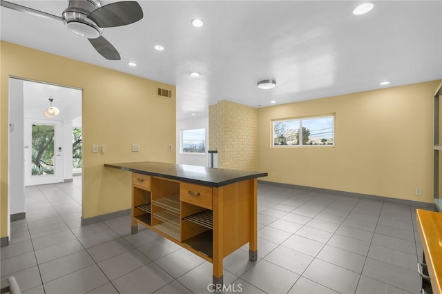 kitchen featuring open shelves, dark countertops, recessed lighting, visible vents, and tile patterned floors