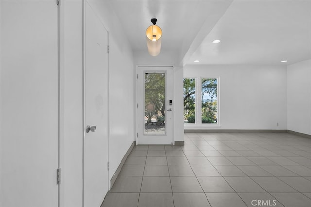 tiled entryway featuring recessed lighting and baseboards