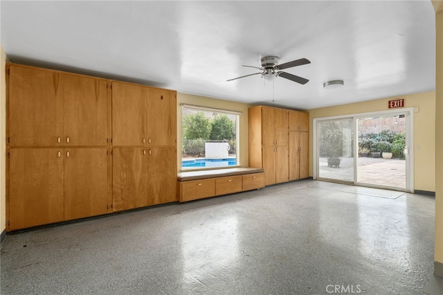 unfurnished room featuring ceiling fan and a wealth of natural light