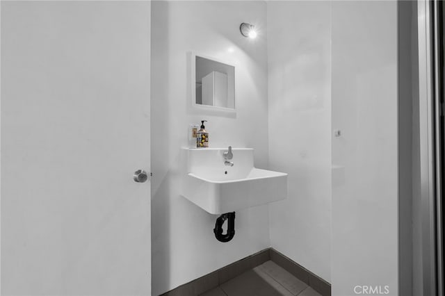 bathroom with baseboards and tile patterned floors