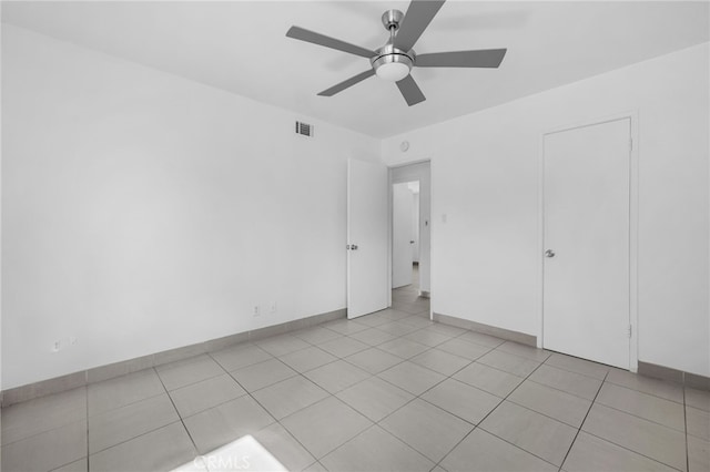 unfurnished bedroom with visible vents, ceiling fan, baseboards, and light tile patterned flooring