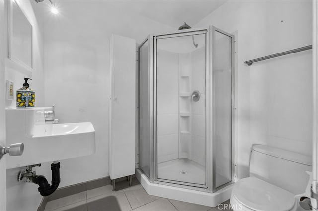 full bathroom with a shower stall, toilet, and tile patterned floors