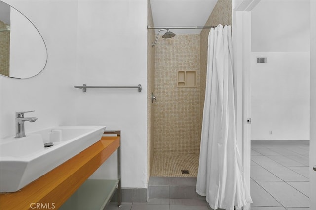 bathroom featuring a stall shower, tile patterned flooring, visible vents, and vanity