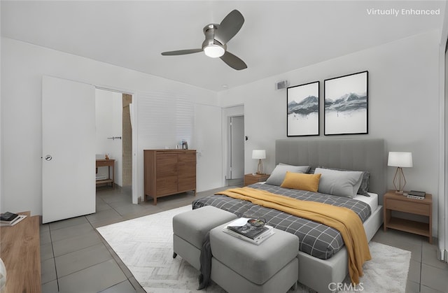 bedroom featuring ensuite bathroom, light tile patterned flooring, and a ceiling fan