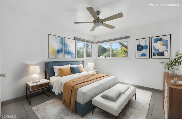 bedroom with light tile patterned floors, a ceiling fan, and baseboards