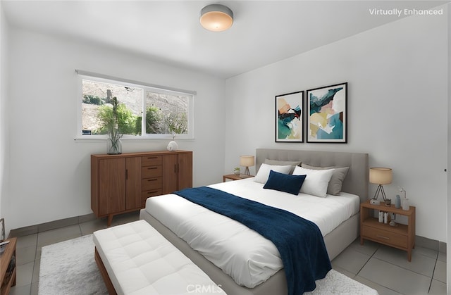 bedroom featuring light tile patterned floors and baseboards