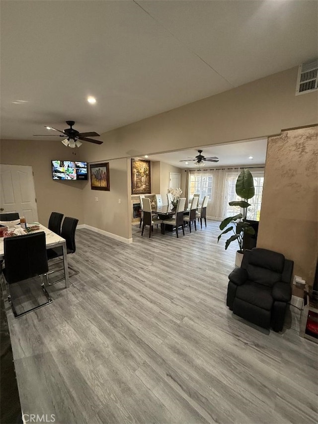 living room featuring wood-type flooring and ceiling fan