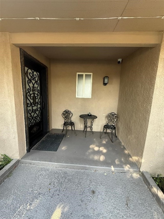 entrance to property featuring stucco siding