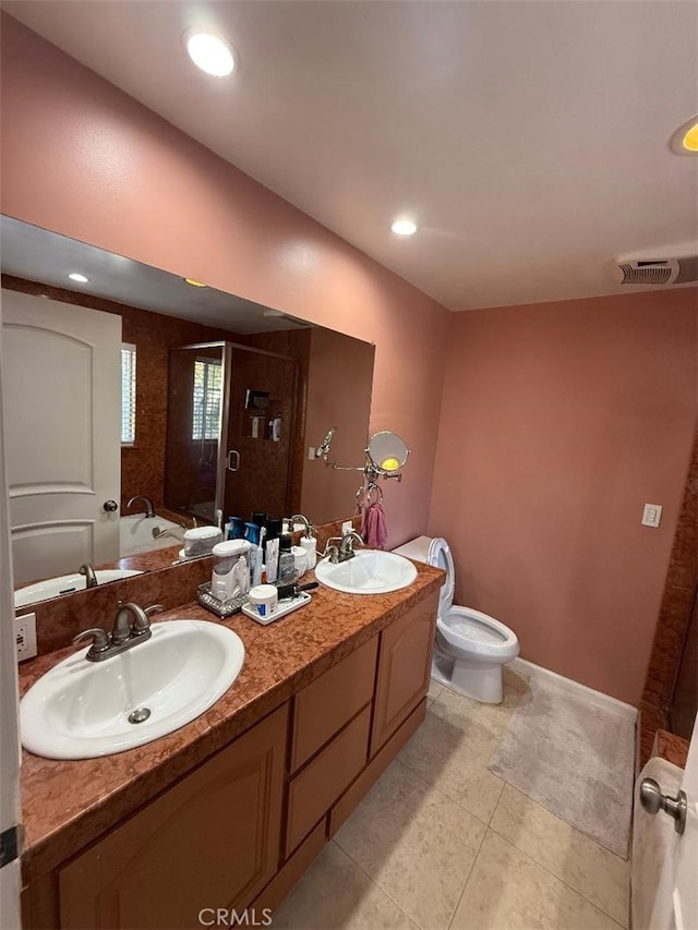 bathroom featuring a shower with door, vanity, tile patterned flooring, and toilet