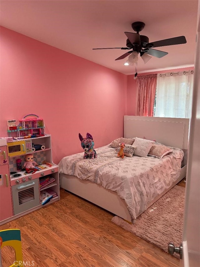 bedroom featuring hardwood / wood-style flooring and ceiling fan