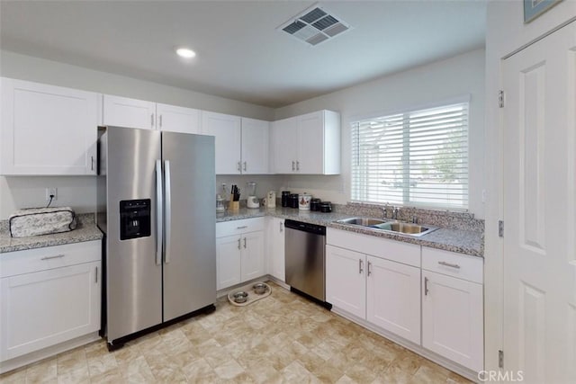 kitchen featuring white cabinets, recessed lighting, visible vents, a sink, and stainless steel appliances