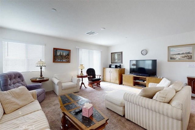 carpeted living area featuring visible vents