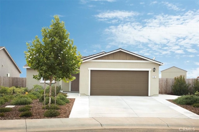 ranch-style house with a garage, driveway, stucco siding, and fence