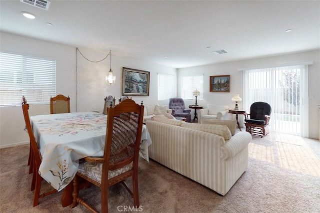 dining room featuring plenty of natural light, carpet, and visible vents